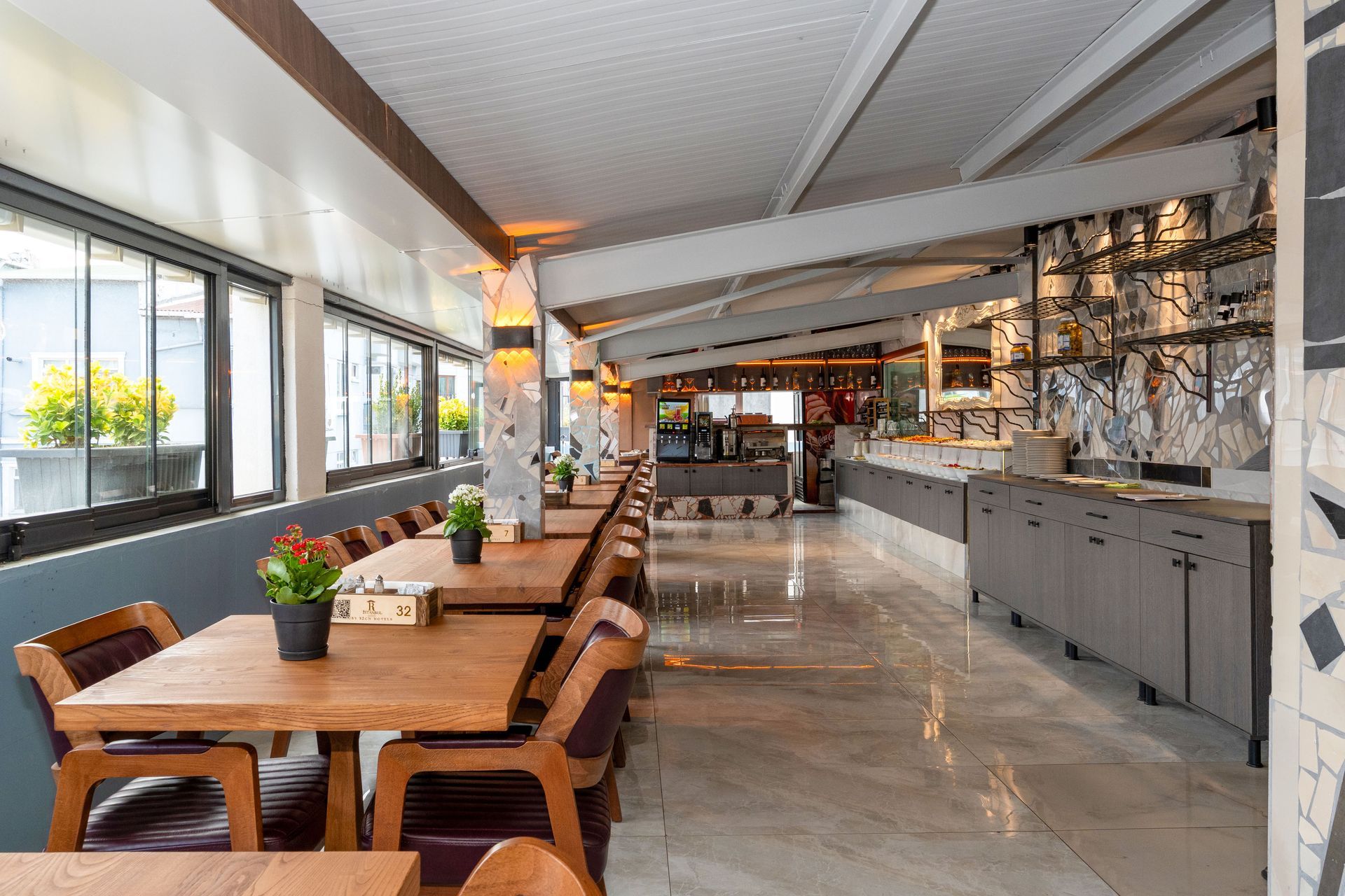 Istanbul By Rich Hotel | Restaurant featuring wooden tables, chairs, and countertops. Natural light in through the windows.