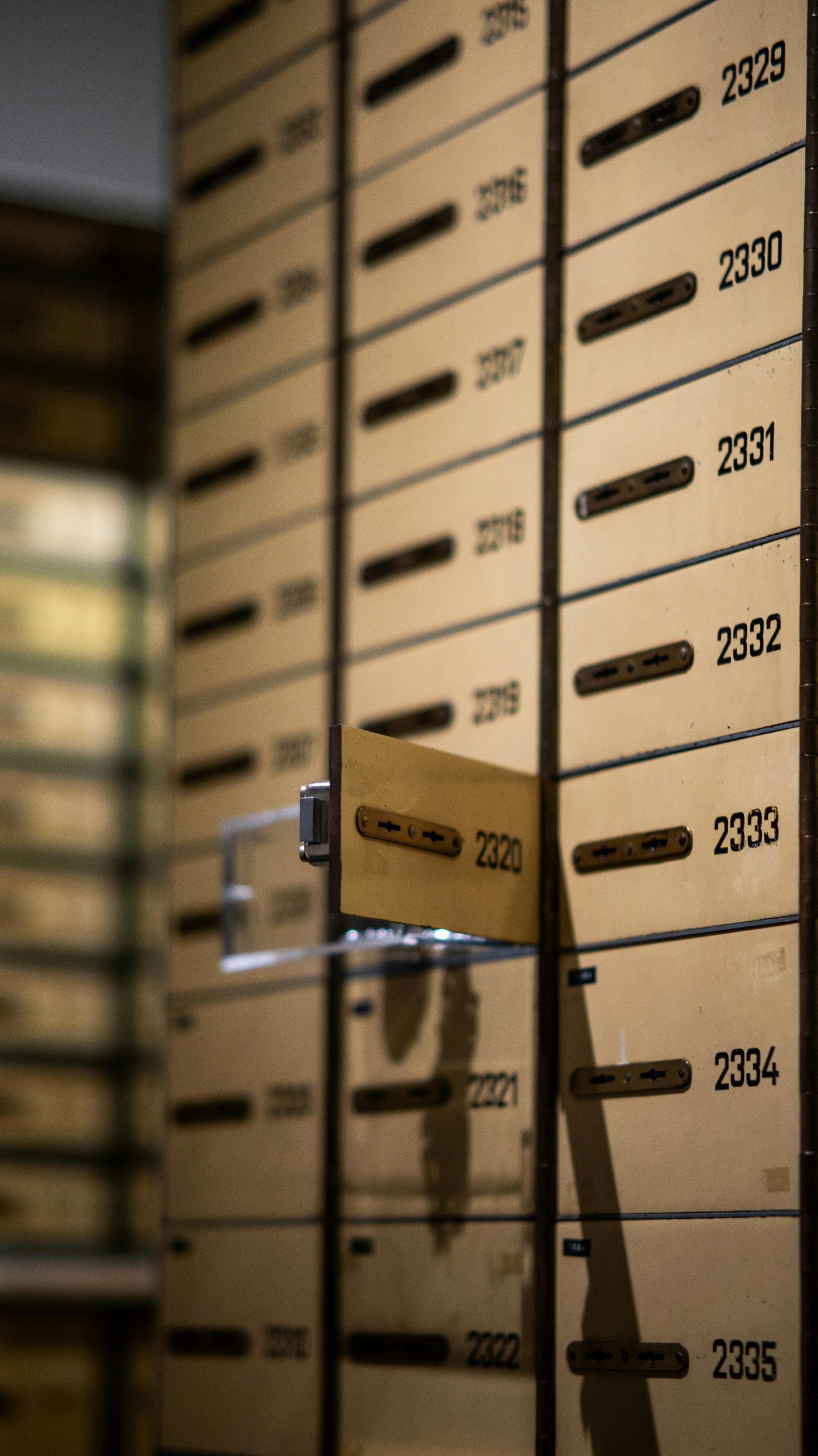 Mays Otel | Rows of numbered wooden storage boxes, one drawer pulled open with label visible.