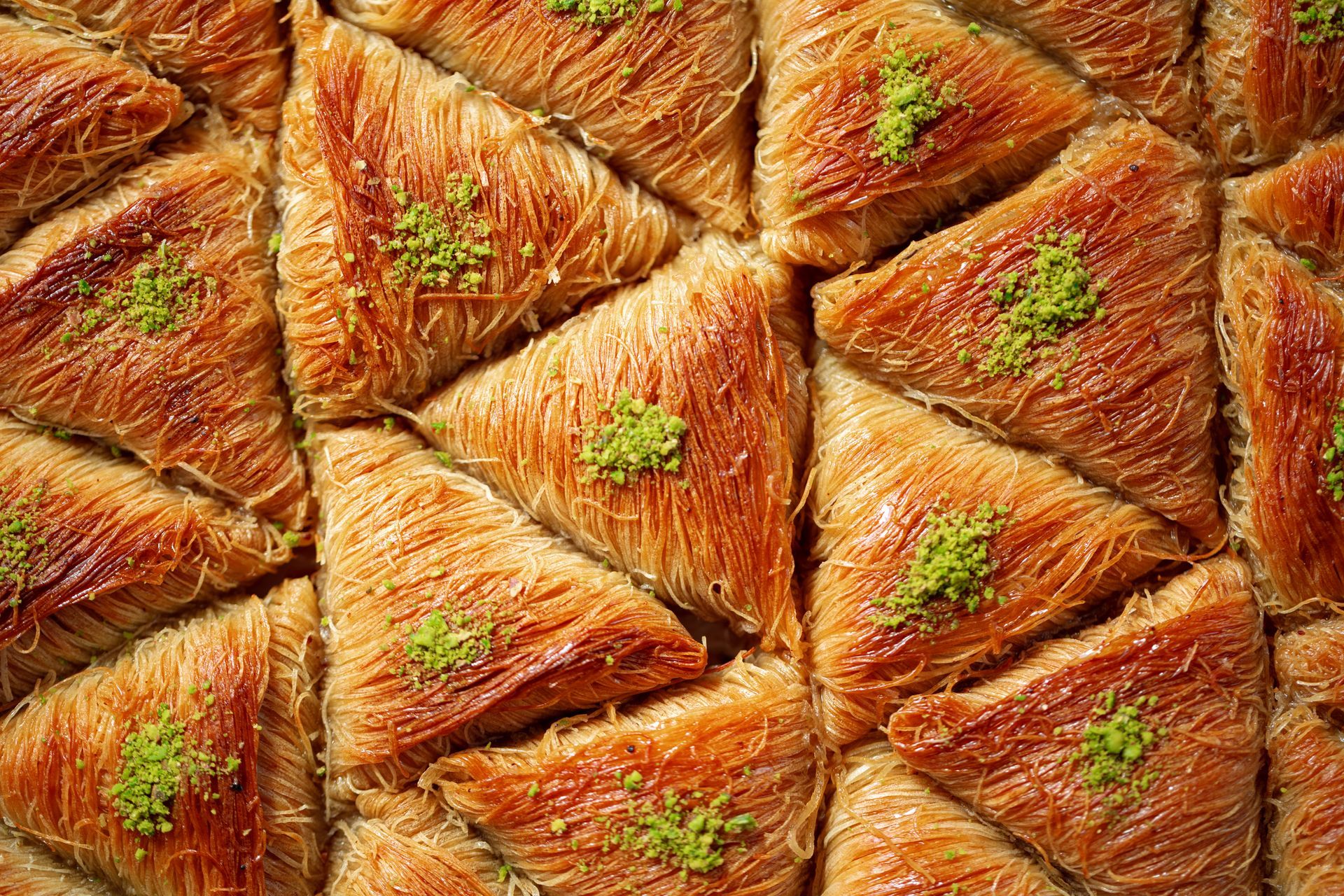 Istanbul By Rich Hotel | Turkish Baklava | A triangular-shaped, golden brown dessert decorated with pistachios and grilled.