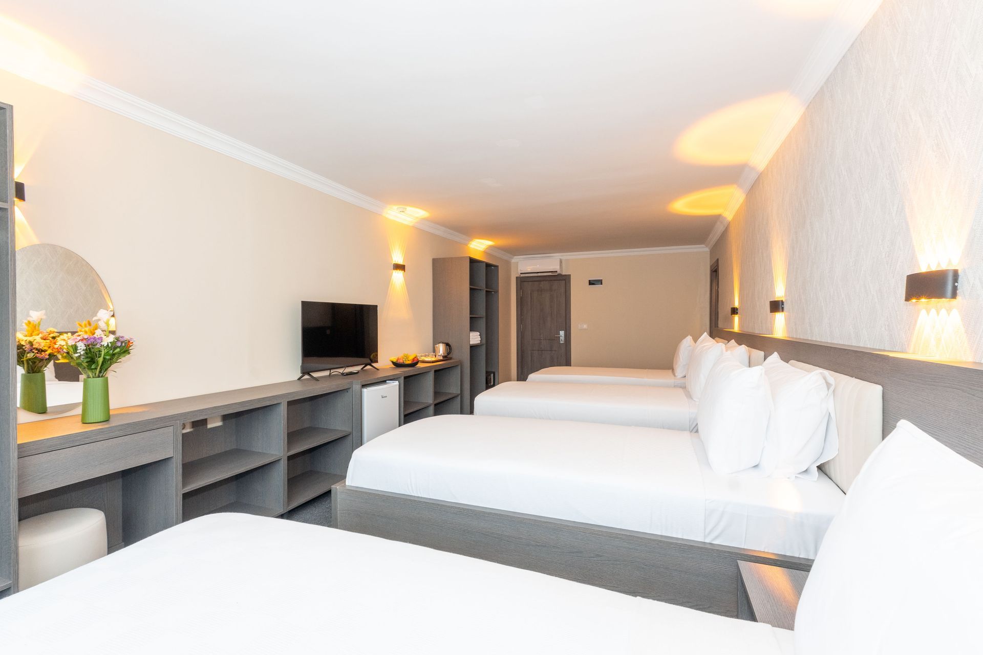 Istanbul Rich Hotel | Hotel room with four beds, neutral colors, small TV, and a vanity.