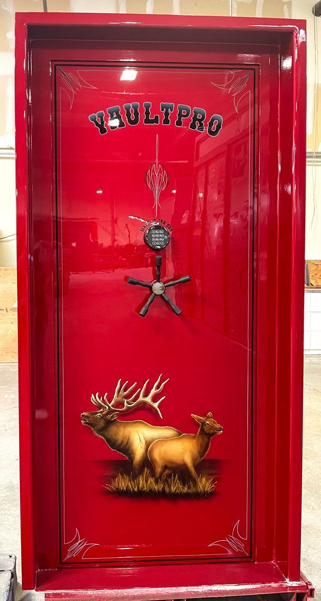Custom Executive model vault door in premium dual-stage Laser Pearl Red gloss finish, and hand applied custom Elk art and pinstripe.