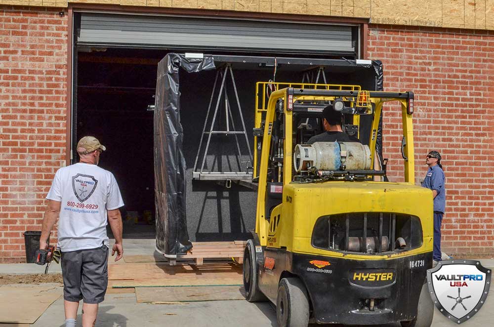 Modular Sections are off loaded from truck and carefully moved inside building.