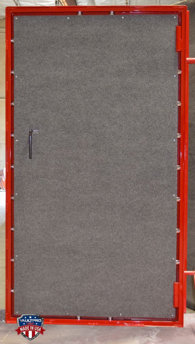 A gray door with a red frame is sitting on a table