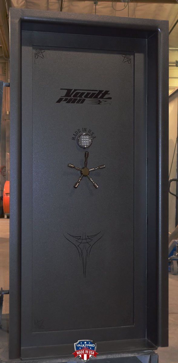 A large black safe is sitting on top of a pallet.