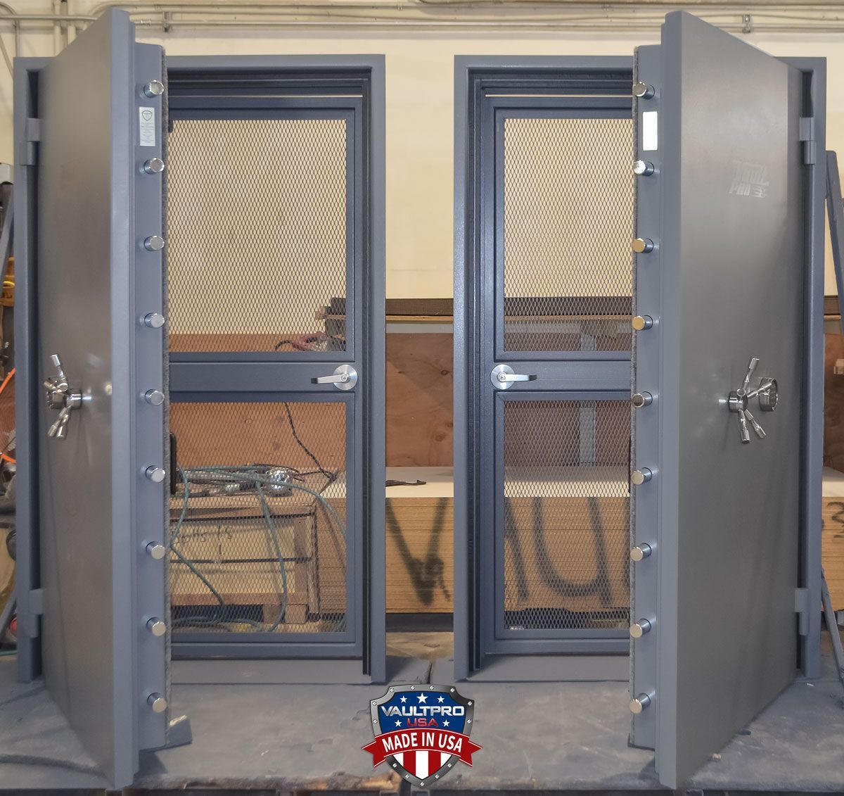 Two Elite Model vault doors, ADA compliant, with Day Gate. These outswing vault doors are mirrored. One opens right, the other left. Low profile lock and handle, and no-step at threshold ADA door.