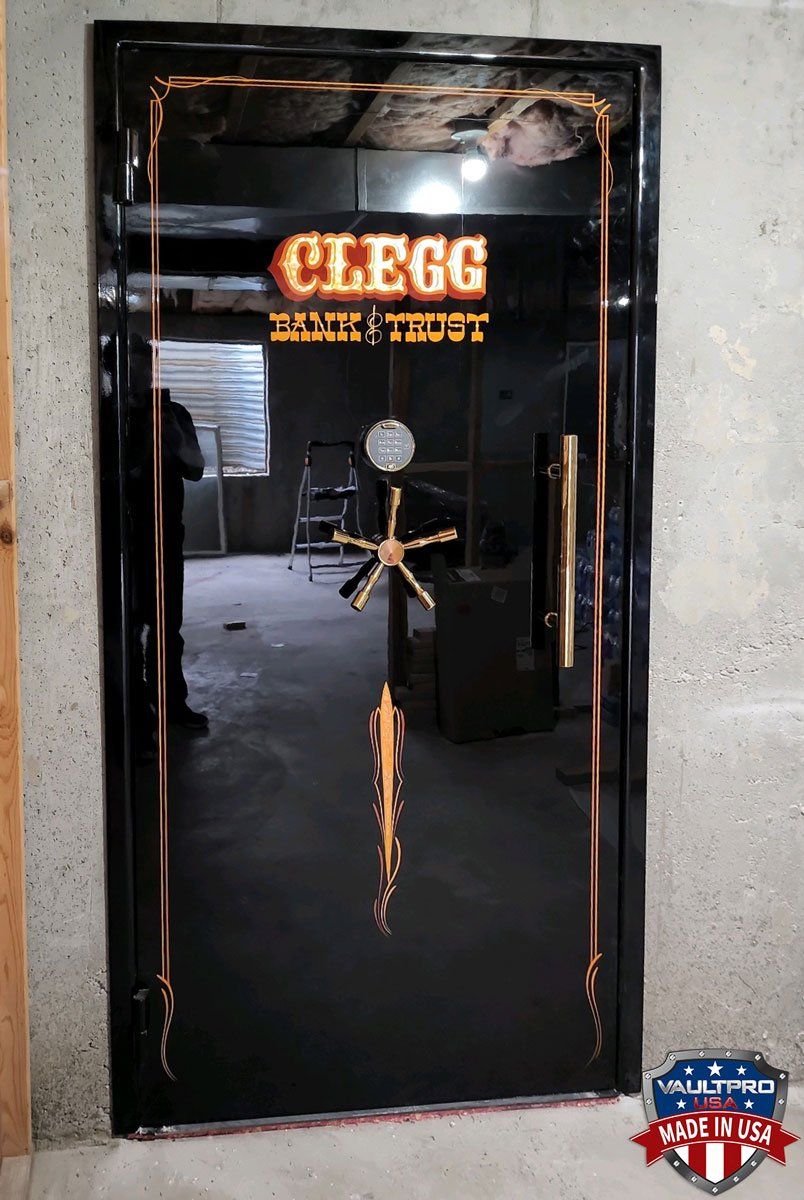 Custom vault door with gloss black finish and custom hand painted art by Tom Kelly.