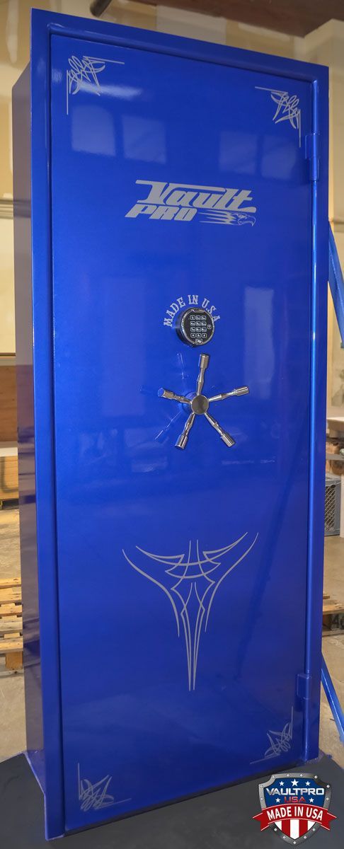 A blue safe is sitting on a carpet in a room.