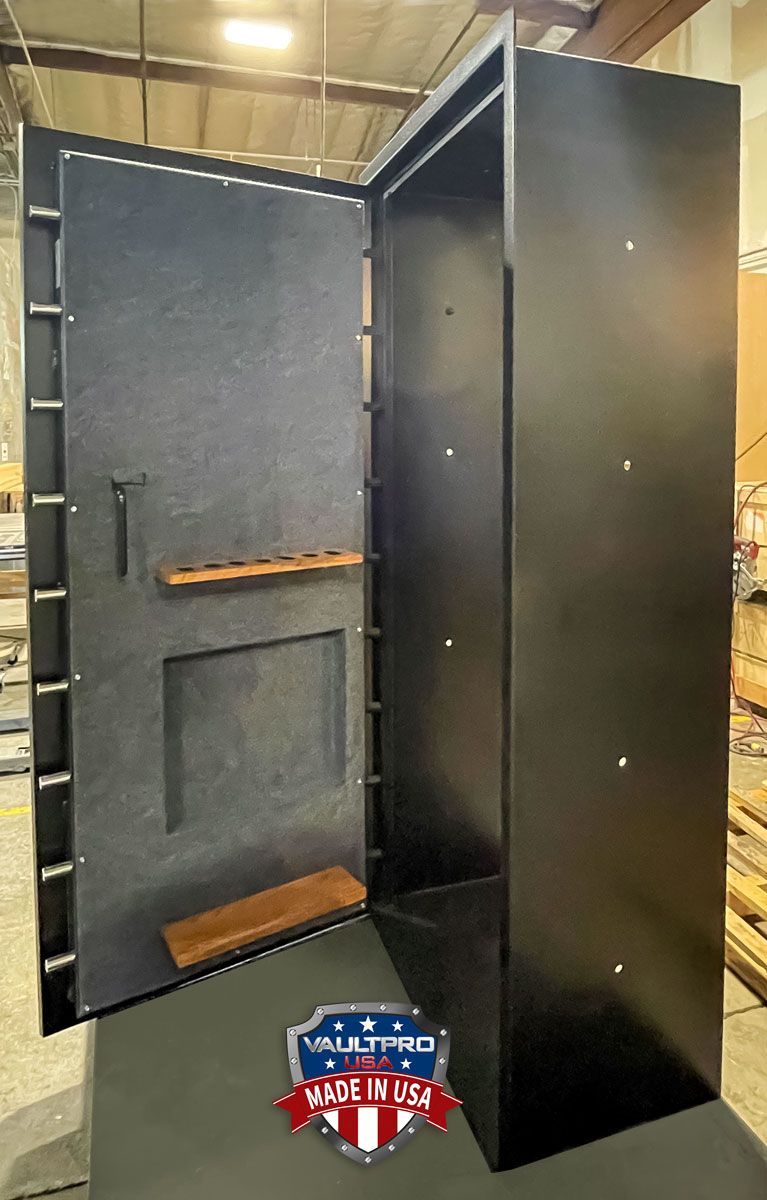 Executive model vault door with extra deep frame and gun rack mounted to door back.