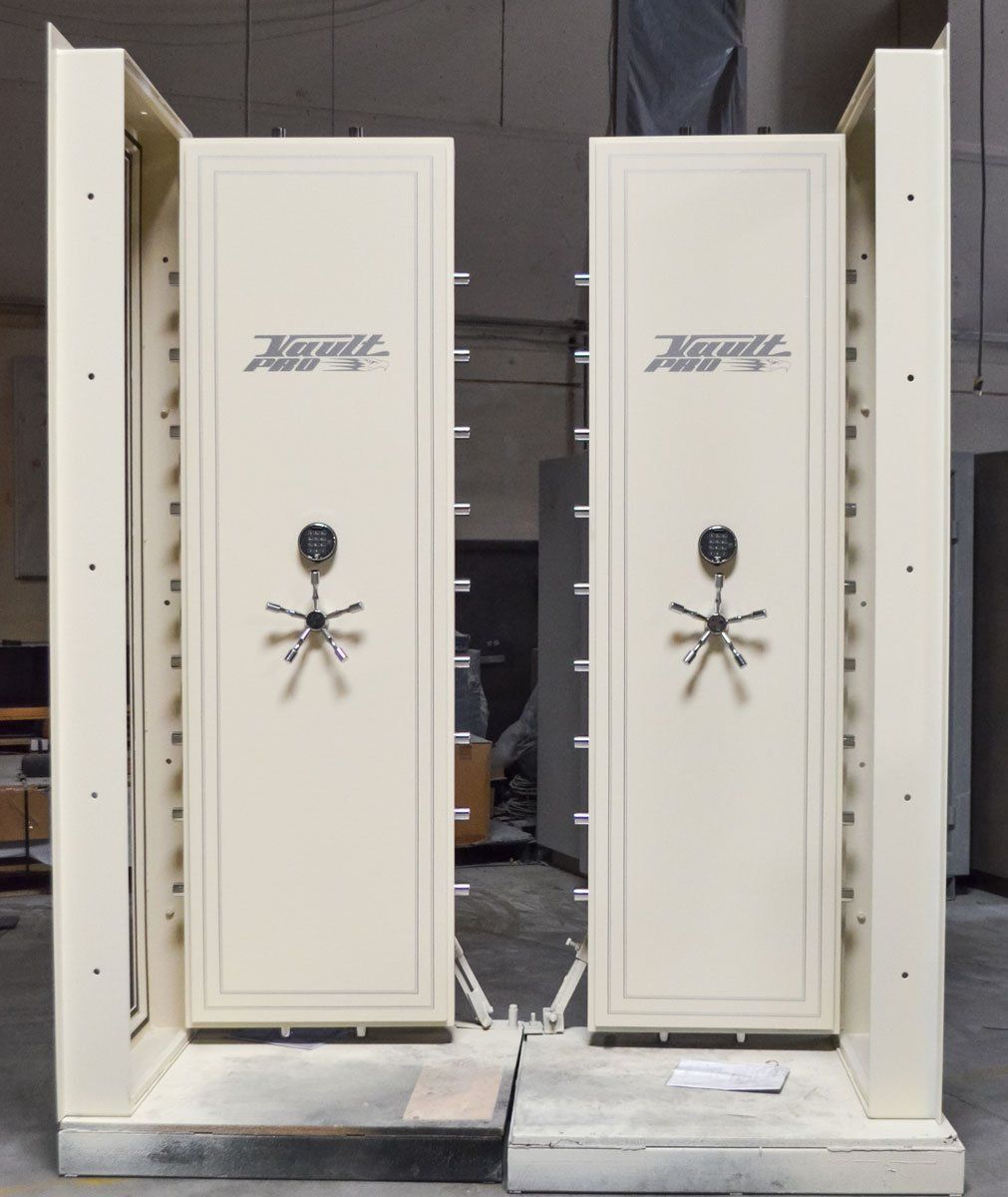 Two white vault doors are sitting next to each other in a room.