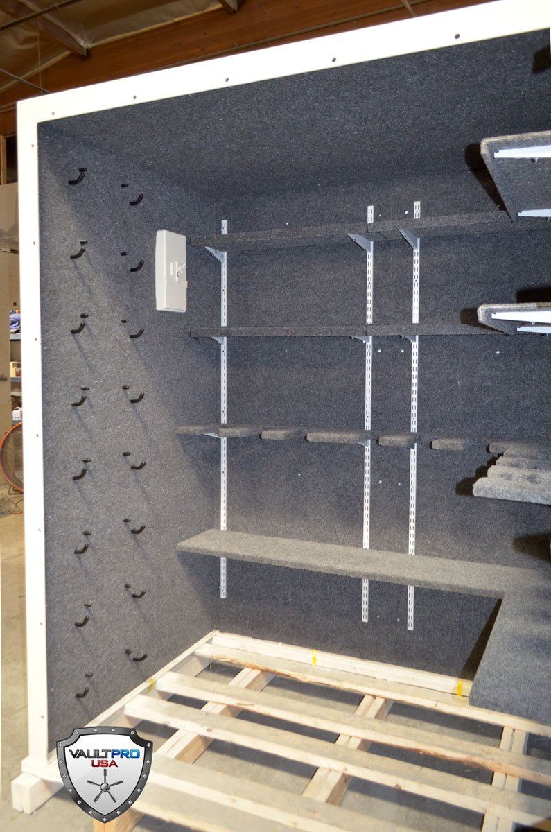 Modular walk in vault room interior with custom pistol holders, shelving, fully sealing ventilation cover