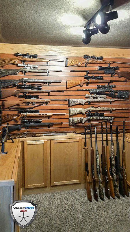 Back wall of vault room with gun storage and cabinets.