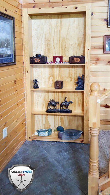 Custom panel and moveable bookcase covers entrance to hidden vault room.