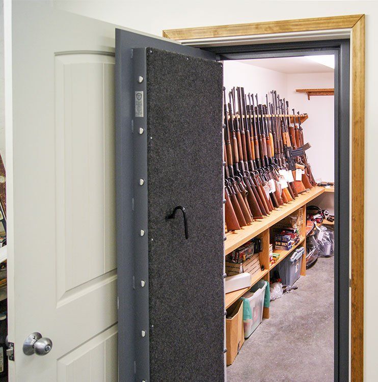 Hidden vault room entry with vault door and guns