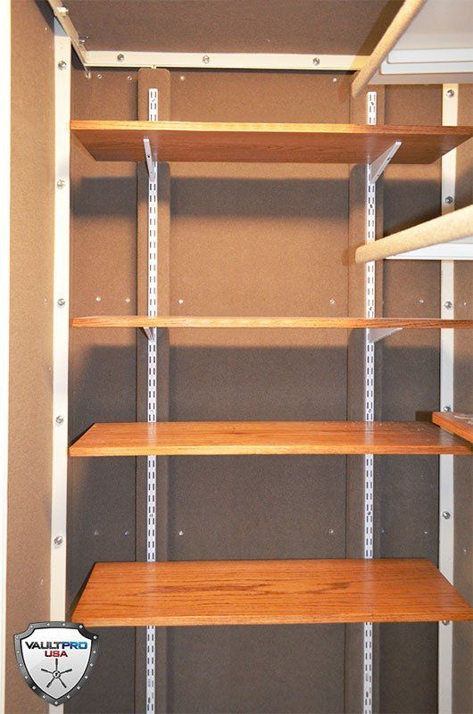 Custom gun room features fully adjustable oak wood shelves.