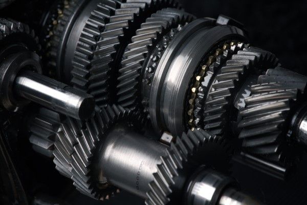 Close-up of a complex mechanical gear system with multiple interlocking gears, shiny metal. | Auto Clinic Care