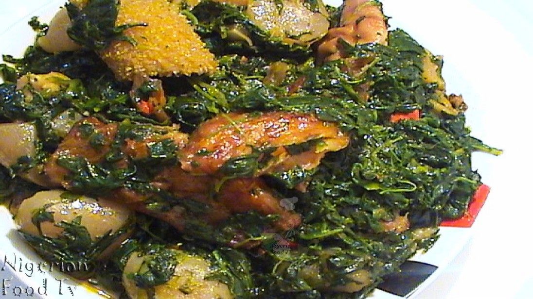 A close up of a plate of food with spinach and meat