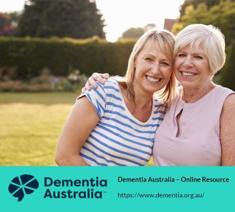 Two Women Are Posing For A Picture With Dementia Australia In The Background — Aged Care in Tamworth, NSW