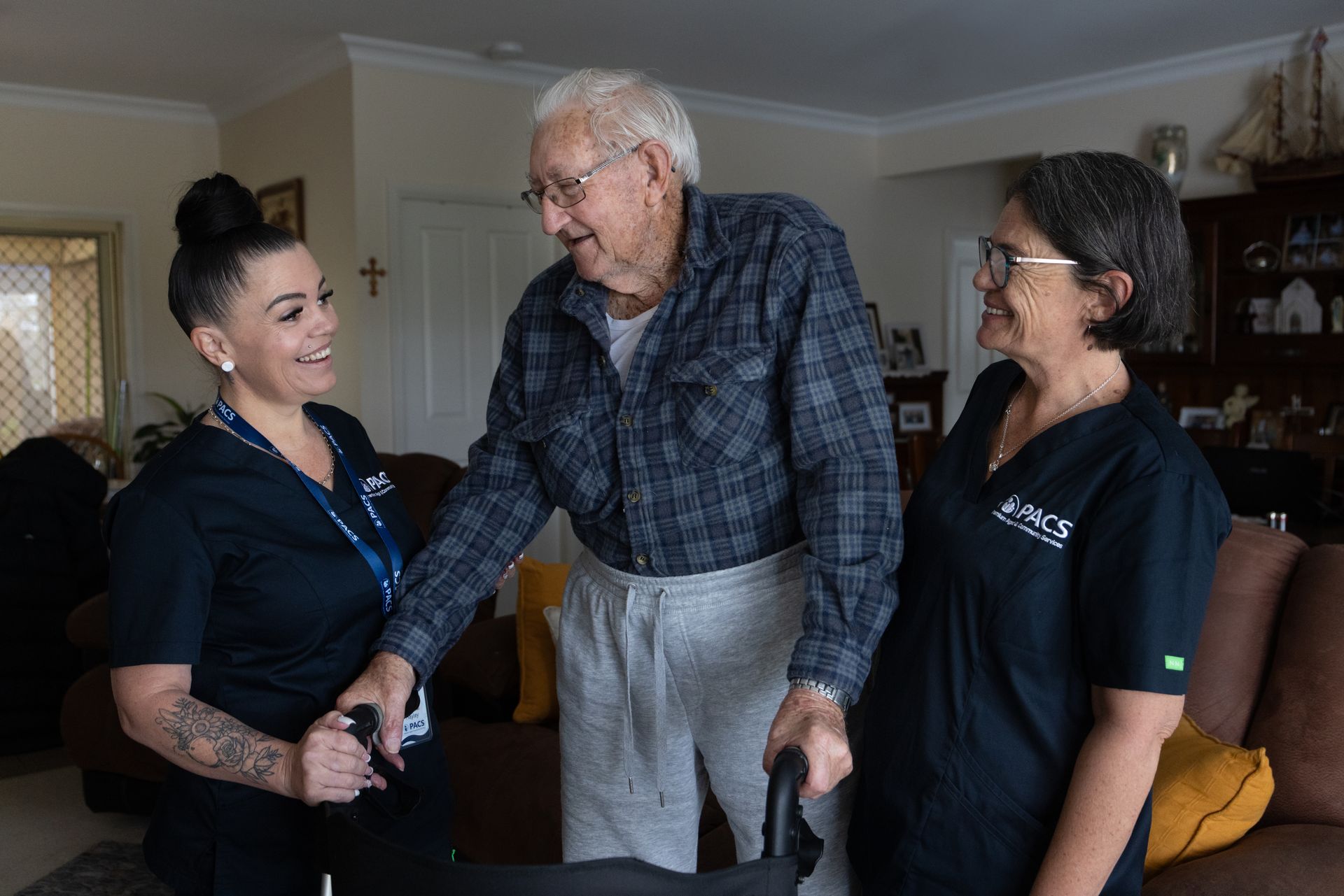 Woman in Navy Top Assists Older Woman in Green Jacket — Premium Aged & Community Services In Tamworth, NSW