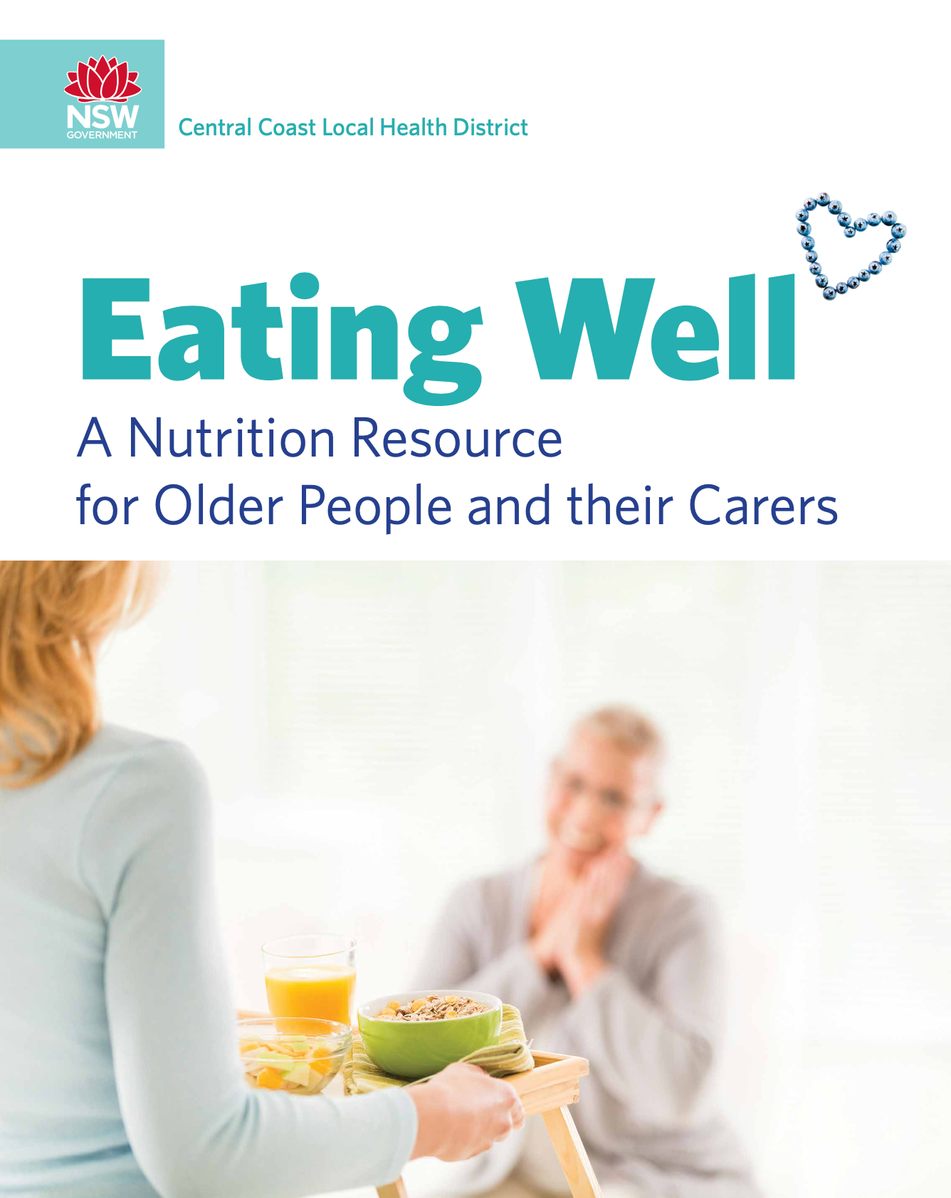A woman is holding a tray of food in front of an older man — Aged Care in Tamworth, NSW