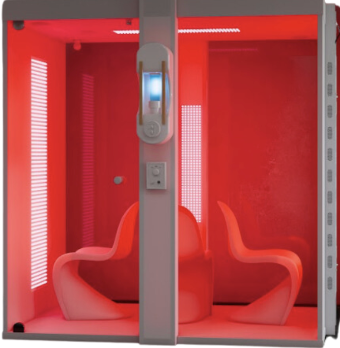 A red room with two chairs and a phone on the wall