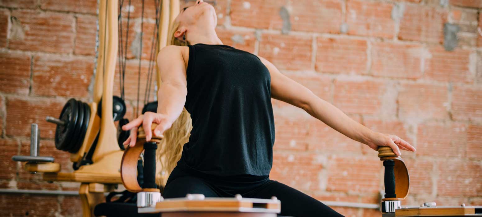 a woman is stretching her arms doing Gyrotonics