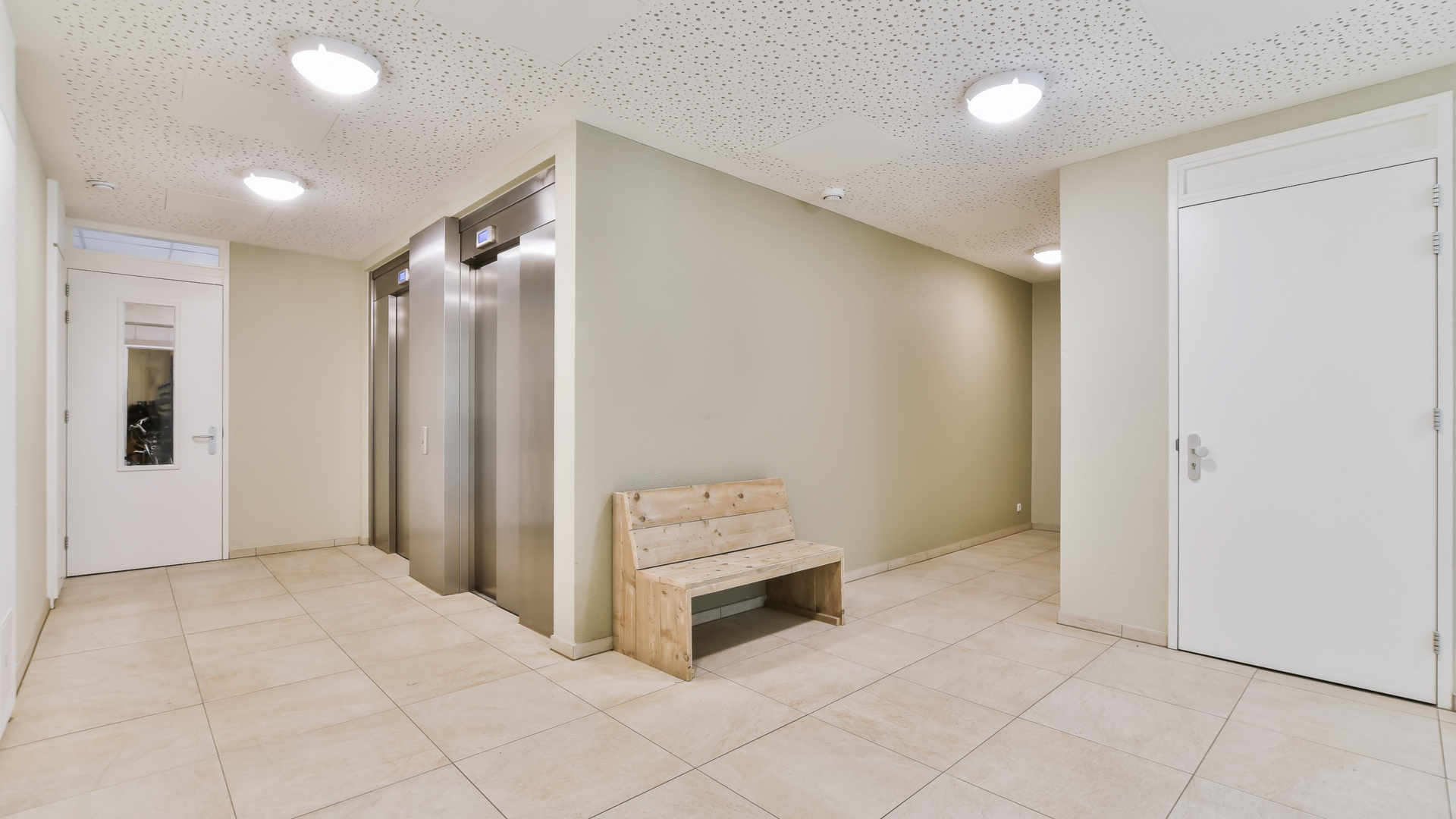 A room with a door open and a toilet in it.