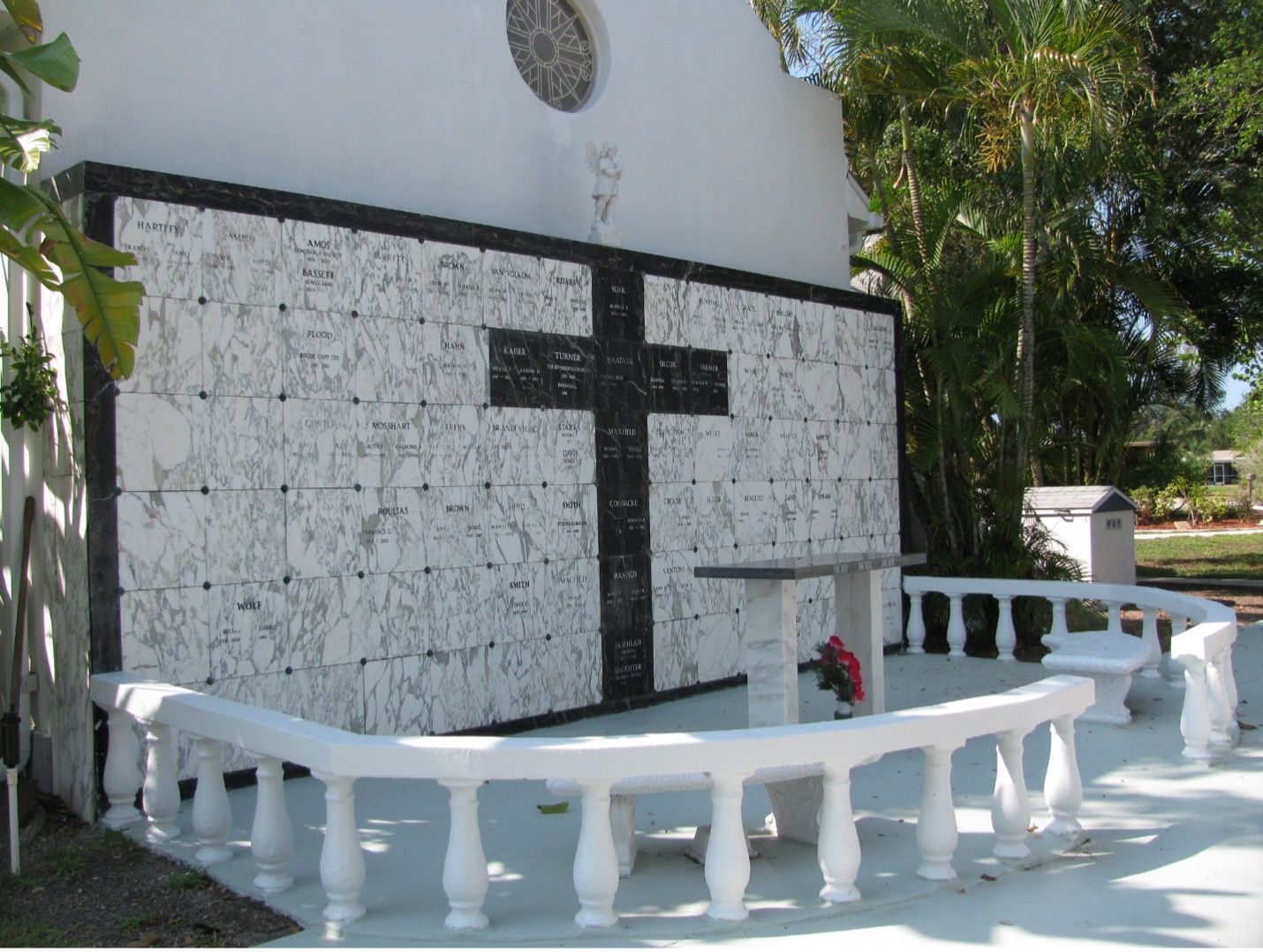 A white wall with a black cross on it