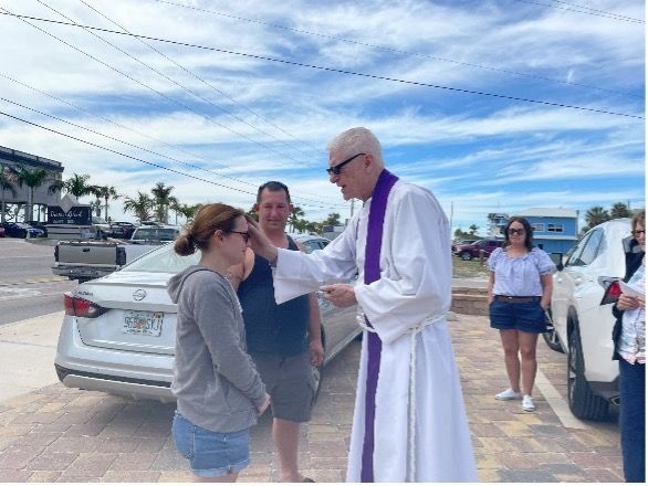 A lady being blessed outside