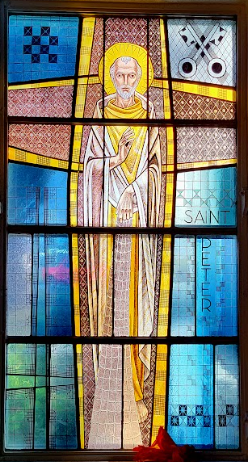 Stained glass window: Saint Peter with golden halo, keys, and inscribed 