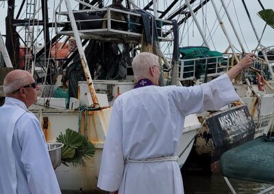 A man in a white robe is pointing at a boat that says miss marine