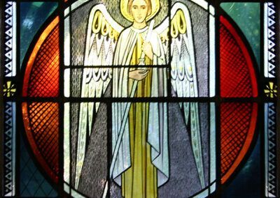 A stained glass window shows an angel with wings