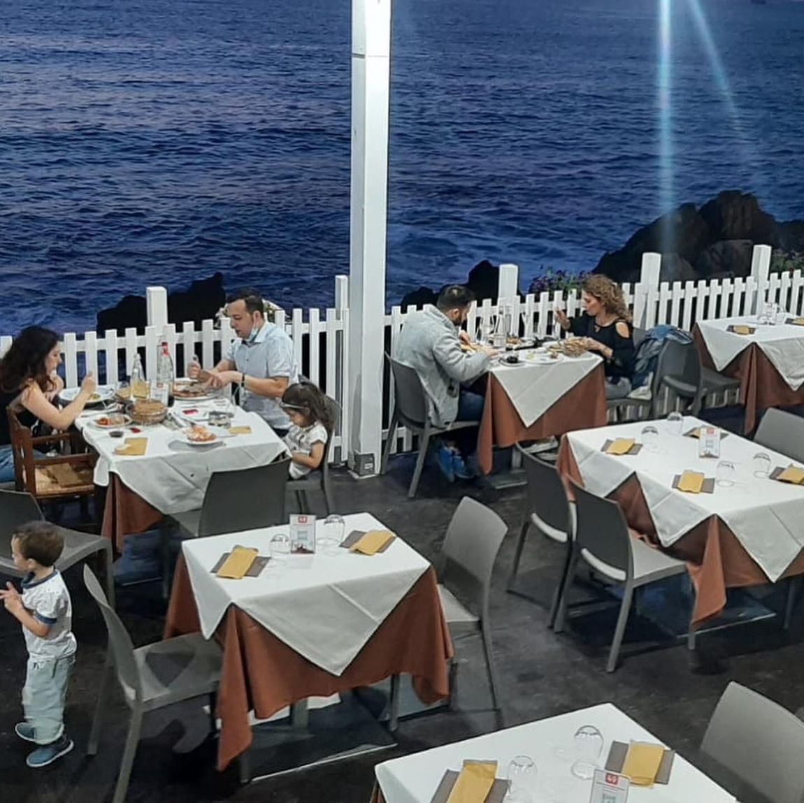 tables outside with a sea view