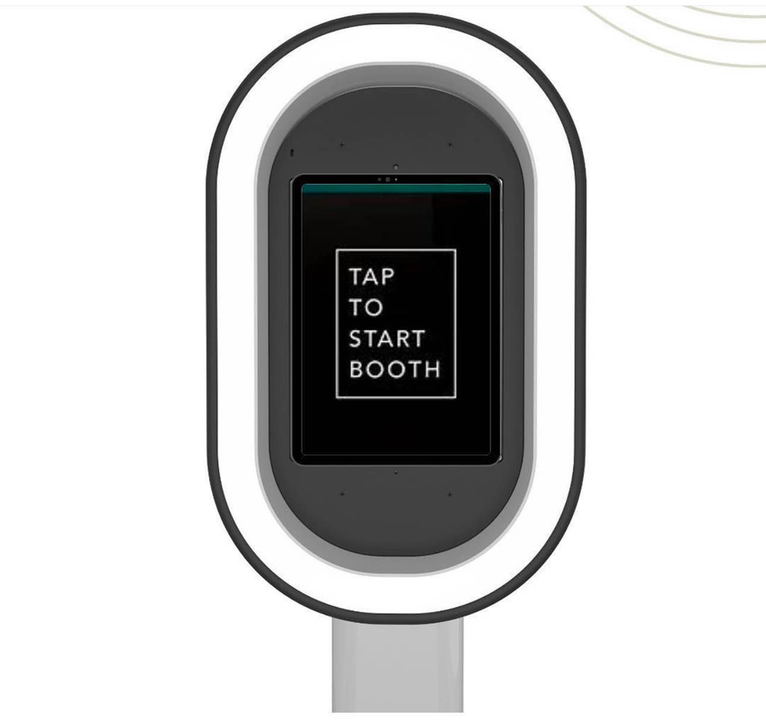 A photo booth with a screen that says tap to start booth.