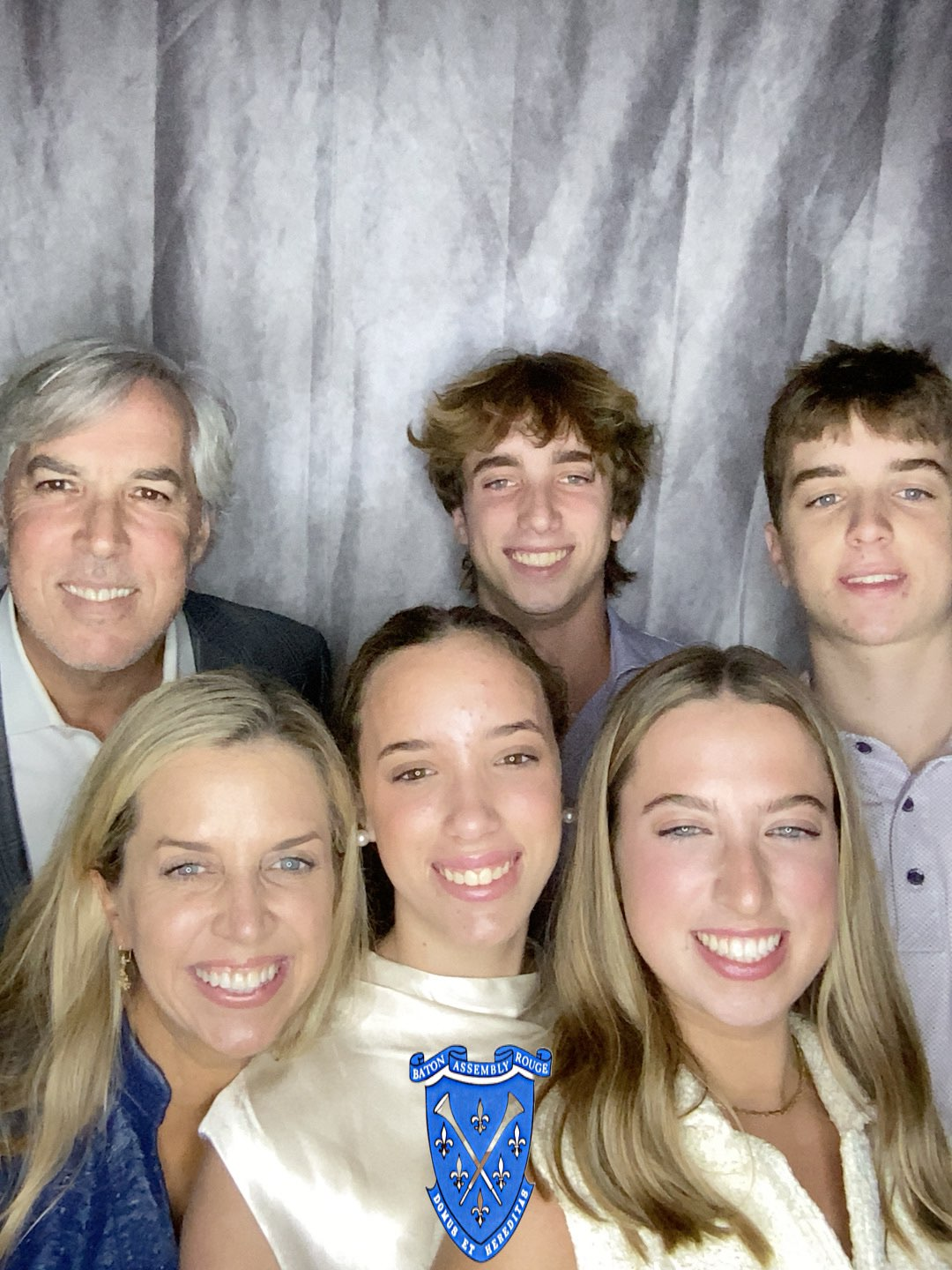 A group of people are posing for a picture in a photo booth.