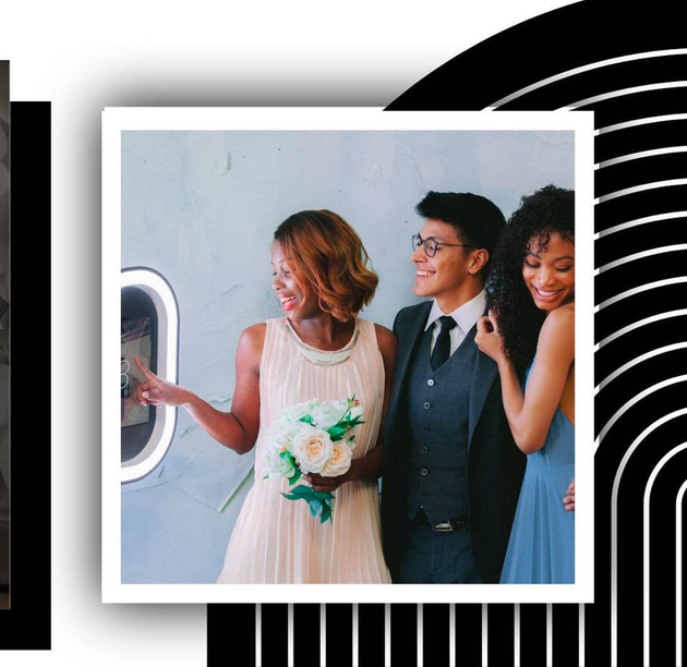 A bride and groom are posing for a picture in a photo booth.
