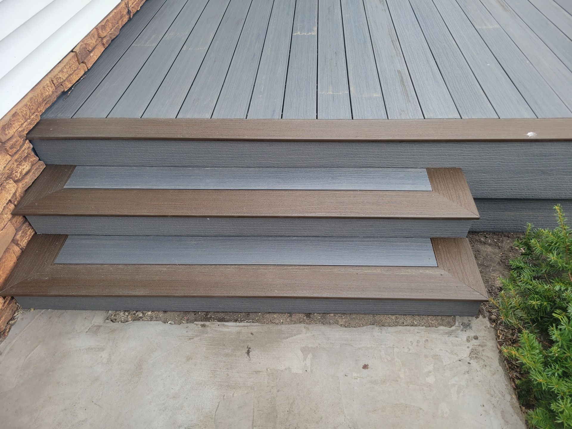 A wooden deck with stairs leading up to it.