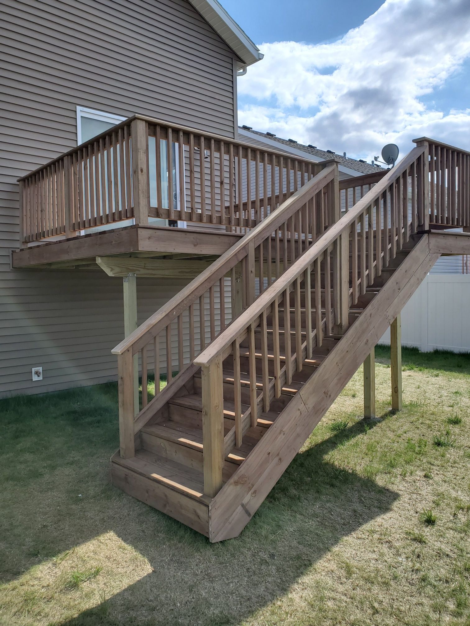 A wooden deck with stairs leading up to it