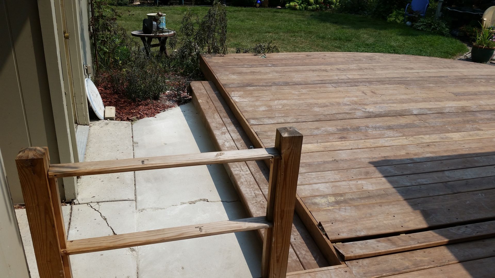A wooden deck with stairs leading up to it