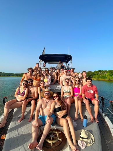 A group of people are posing for a picture on a boat.