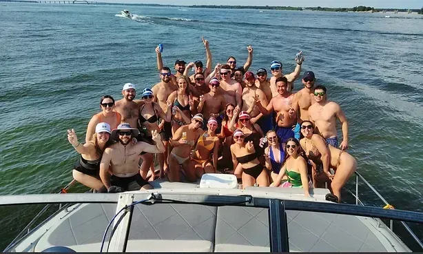 A group of people are posing for a picture on a boat.