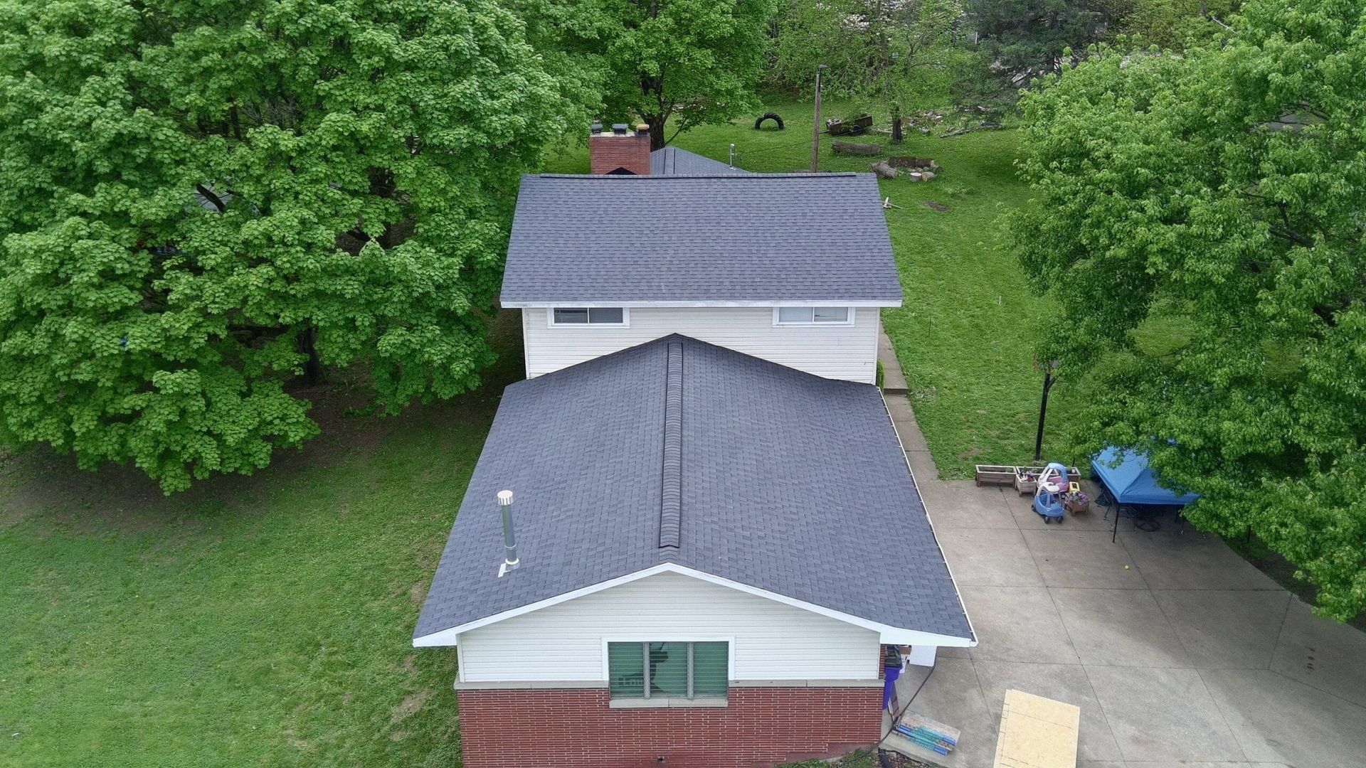 Diamond Roofing Pros worker securing a flashing repair on a chimney.