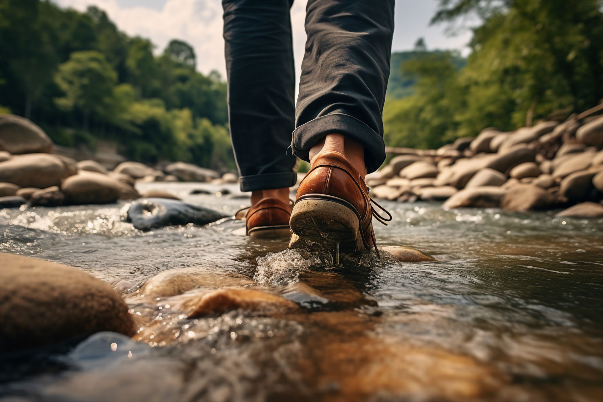 a person is walking across a rocky river .