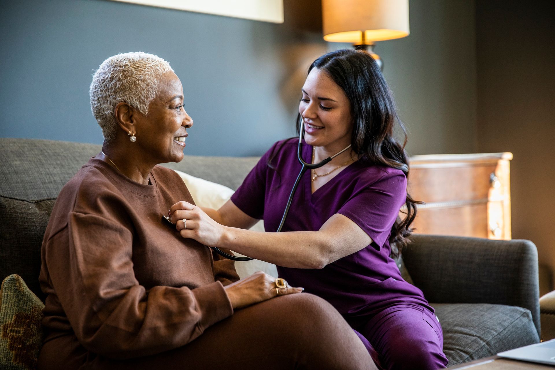 Healthcare worker uses stethoscope to check senior’s heart. Healthcare worker uses stethoscope to check senior’s heart.