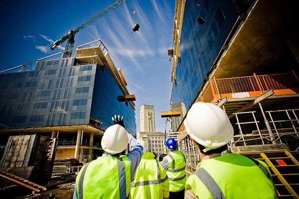 Building under construction with workers Building under construction with workers