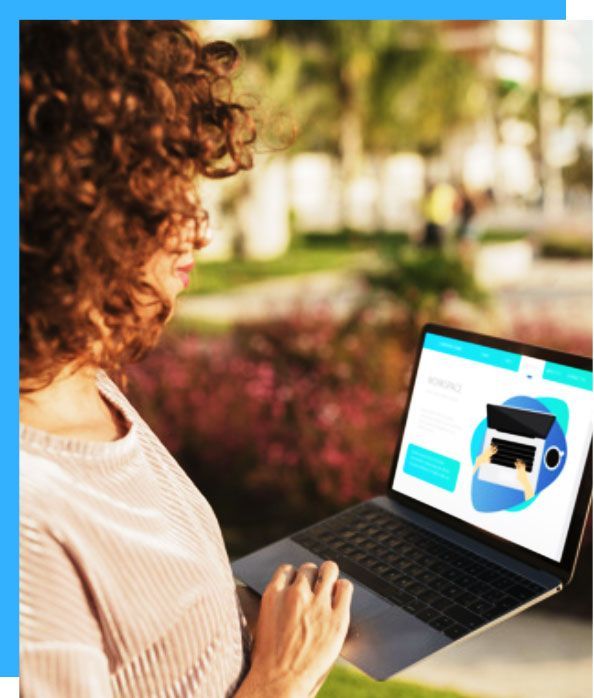 A woman with curly hair is using a laptop computer