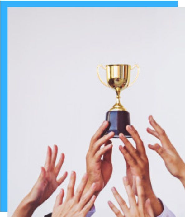 A group of people are holding a trophy in their hands.