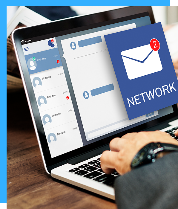 A person is typing on a laptop with an envelope on the screen that says network