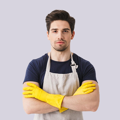 Man in apron and yellow gloves with arms crossed.