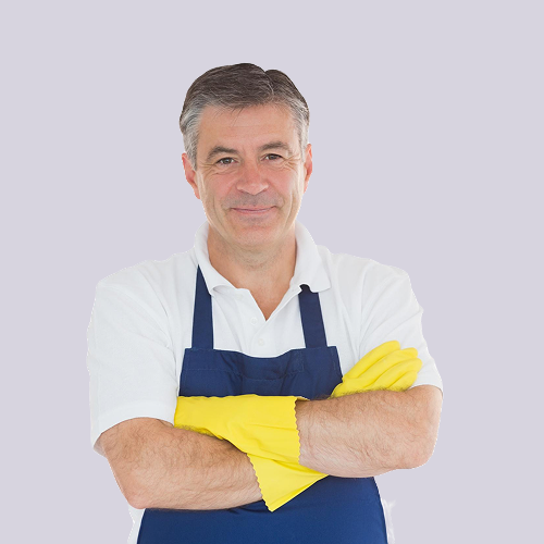 Man wearing apron and yellow gloves, arms crossed, smiling.