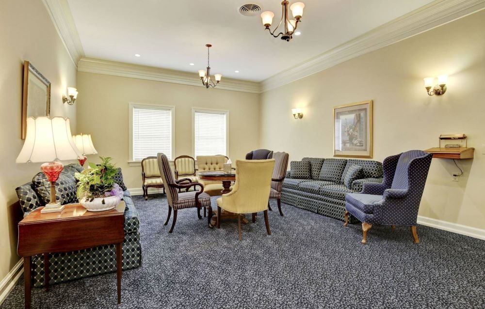 A living room with a couch , table and chairs.